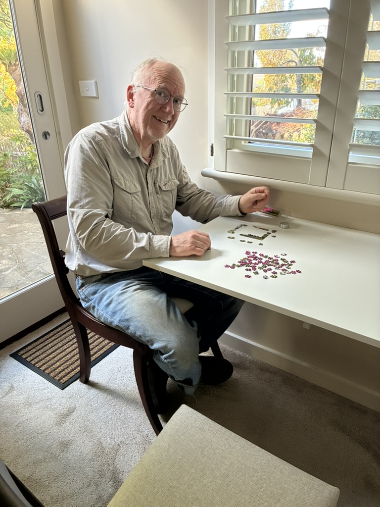 Paul sitting at the new flip up table in the guest suite