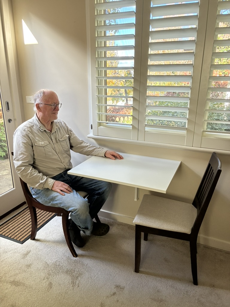 Paul at the new flip up table with two chairs.